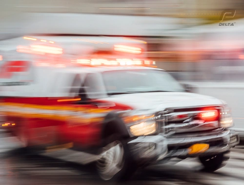 box truck with delta p ny company logo on the side & motion blurred as in emergency response mode